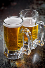 Light beer in a glass on an old background.
