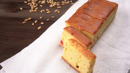 Slices of home made wholemeal bread on a white background with wheat and flour.