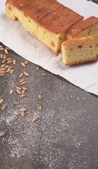 Slices of home made wholemeal bread on a white background with wheat and flour.