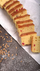 Slices of home made wholemeal bread on a white background with wheat and flour.