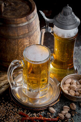 Light beer in a glass, on an old background.