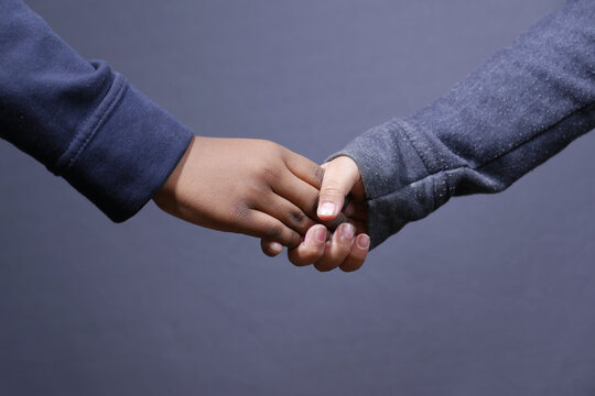 f child girl holding hand of her bother 