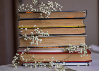 a stack of books with a gypsophila decor	