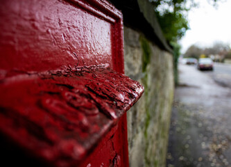 wall postbox with crumbling paint