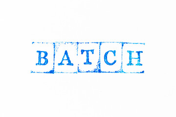 Blue color ink rubber stamp in word batch on white paper background