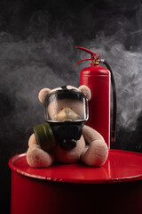 the mascot of the fire brigade is a teddy bear in a gas mask with a fire extinguisher in smoke on a...