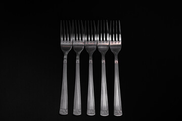 Plugs with metal, silver, lie on a black background