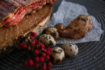 A delicious piece of meat cooked on the grill lies on a wooden board with berries