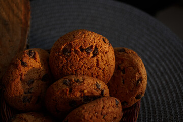 Oatmeal cookies with chocolate chips lie in a basket