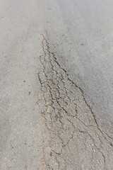 Surface of asphalt driveway with crack