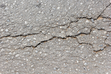 Surface of asphalt driveway with crack