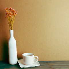Cup of tea with dry flowers on blue painted wooden table. brown wall background. vintage retro filter