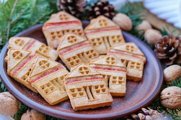 Christmas eve. Cookies in shape of houses and cup of tea