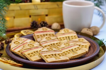 Christmas eve. Cookies in shape of houses and cup of tea