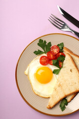 Plate of tasty breakfast on violet background
