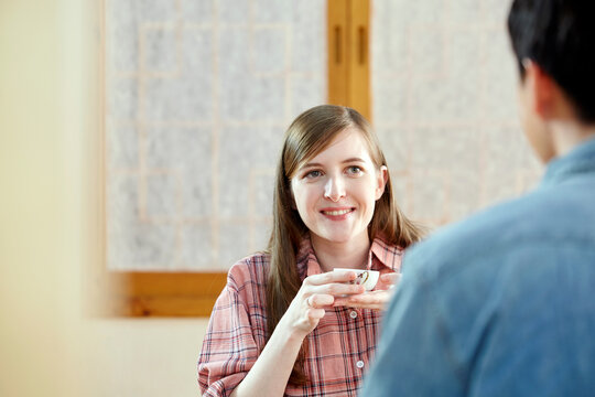 A foreigner and a Korean couple having a tea ceremony in a traditional Korean house