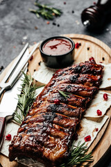 grilled pork ribs BBQ served on wooden cutting board, banner, menu, recipe place for text, top view