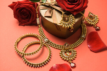Beautiful Indian gold jewelry set with necklace and bangles. Close up jewellery and ornaments for...