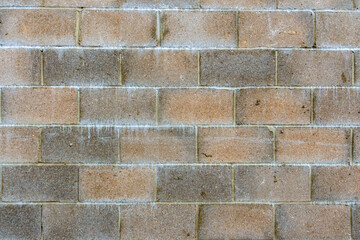 Section of a red and grey breeze block wall