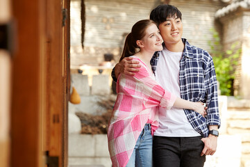 A young couple of a Western woman and a Korean man dating in a traditional Korean house