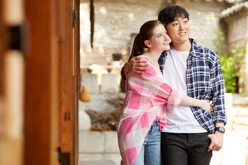A young couple of a Western woman and a Korean man dating in a traditional Korean house