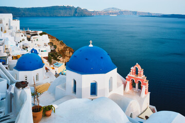 Fototapeta na wymiar Famous view from viewpoint of Santorini Oia village with blue dome of greek orthodox Christian church