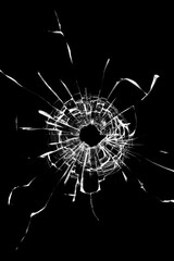 Photo effect of broken glass, a hole with cracks in the glass on a dark background