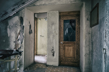 The old interior of an abandoned manor. Staircase. Nice old elevator door. Shabby walls. Ancient architecture.