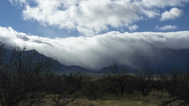 Time lapse of sunrays and fog in a mountain valley