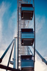 Close up of a Ferris wheel against blue skies 
