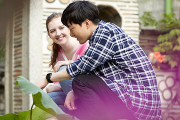 A young couple of a Western woman and a Korean man dating in a traditional Korean house