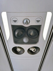 Commands for air conditioning, lights and crew call button in the aircraft cabin. Detail of signage...