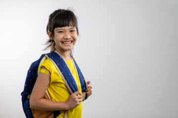  Asian young girl showing her arm with yellow bandage after got vaccinated or inoculation, child...