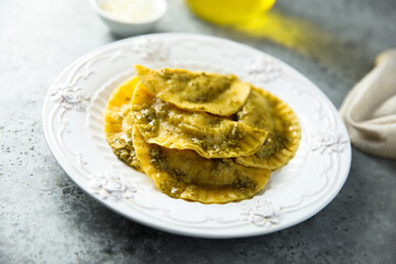 Traditional homemade ravioli with pesto sauce