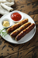 Homemade roasted sausages with ketchup and mustard	