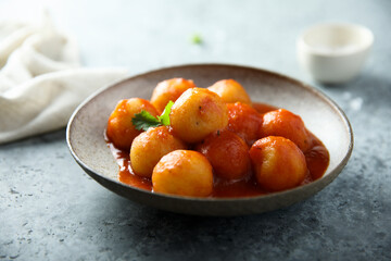 Traditional homemade dumplings with tomato sauce