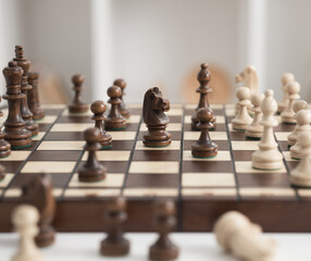 Chess board figures for playing chess are located on a wooden board, in sharpness the main plan is the figure of a chess horse. game of chess
