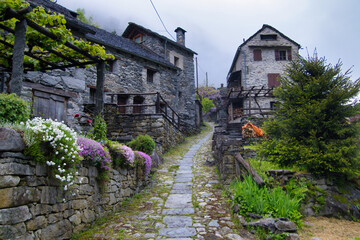 Stone houses an Waterfall Val Bavona, Cevio in Switzerland spring 2021