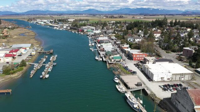 Cinematic 4K aerial drone dolly in shot of Swinomish Village, Swinomish Channel and downtown La Conner on a native American indian tribal reservation