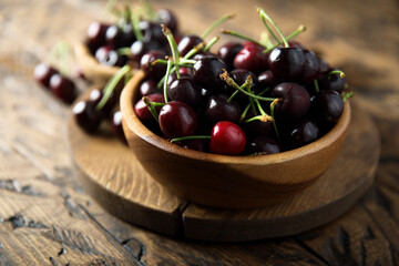 Fresh ripe cherry in a wooden bowl
