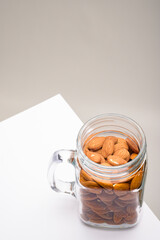 Glass jar filled with a variety of nutrition and healthy snacks and nuts on a dark background