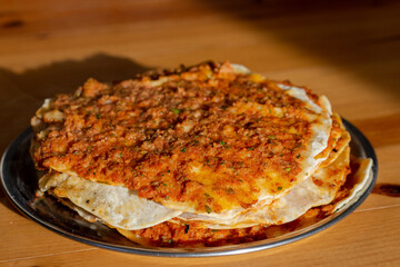 Traditional delicious turkish cuisine, food; Turkish pizza or lahmacun is made of ground beef and onion on a wooden table