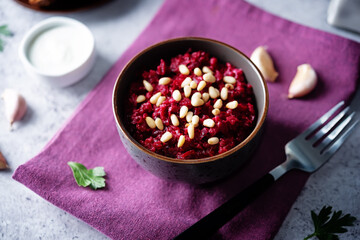 Beetroot salad with pine nuts in a bowl