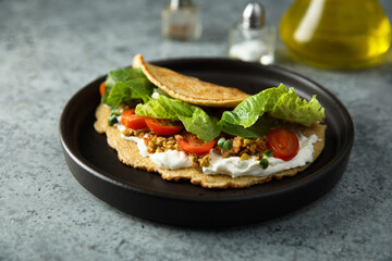 Pancake with olives and tomato