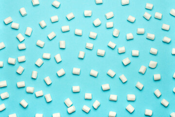 Marshmallows on a blue background. Winter background
