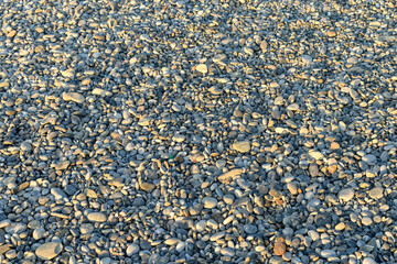 Sea stones of various sizes lie on the shores of the Mediterranean Sea.