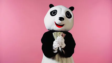 Foto op Plexiglas person in panda bear costume holding dollar banknotes isolated on pink. © LIGHTFIELD STUDIOS