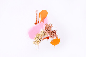 Smears of different colors are made with various cosmetic products isolated on a white background. Texture of multi-colored strokes