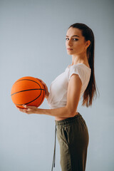 Young woman basketball player isolated at studio