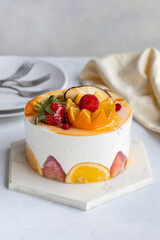 Fruit Parfait Cake on a white background. Fruit cake with white cream. Close-up. Vertical view